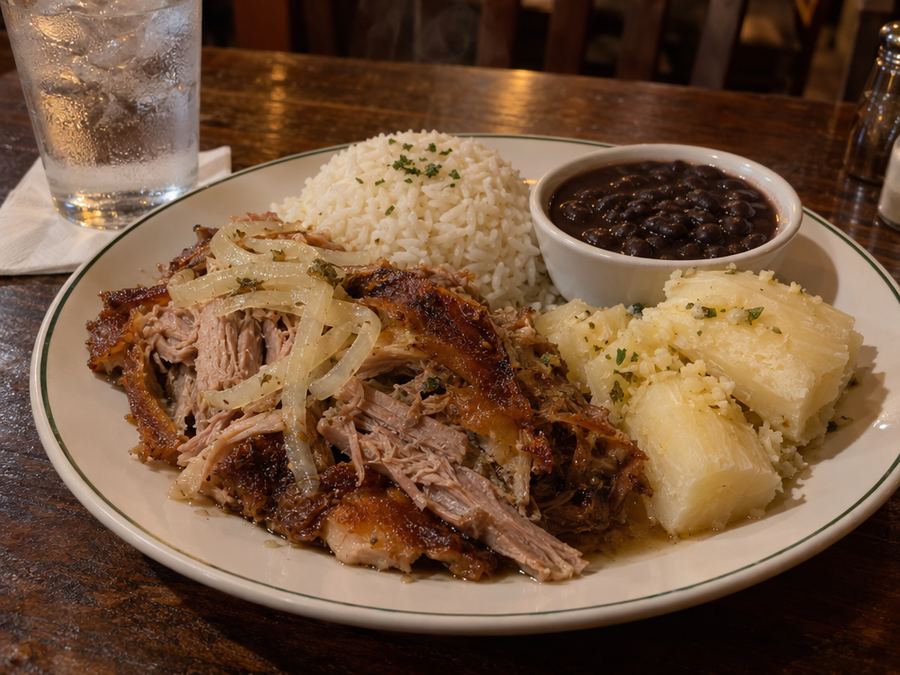 Lechón asado with mojo onions, rice, black beans and yuca